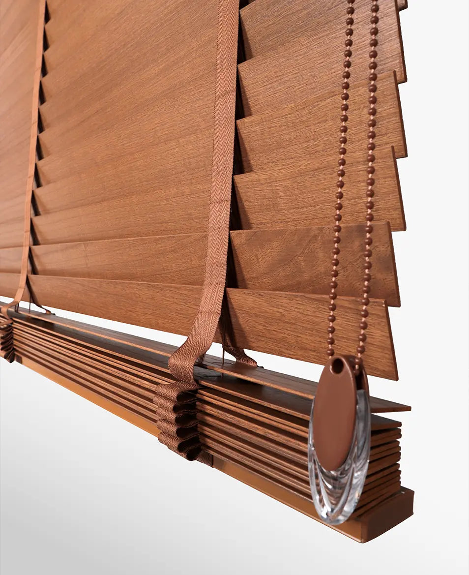 Brown wooden blinds with a decorative finial on a white background